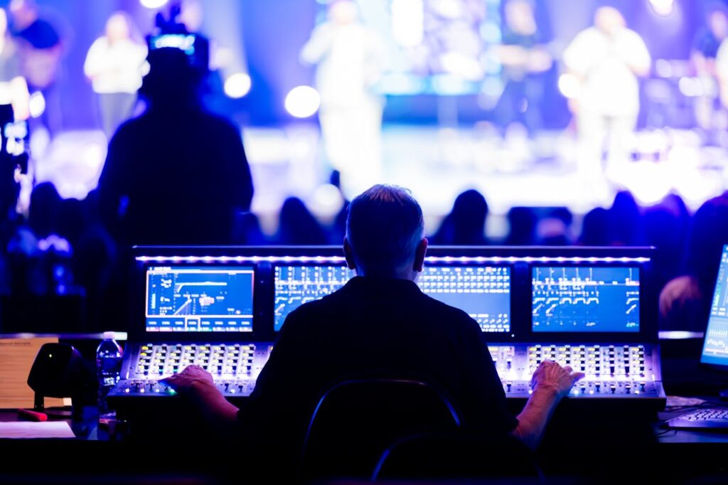 Crafting Captivating Headlines: Your awesome post title goes here Sound engineer operating a digital mixing console during a live concert performance.