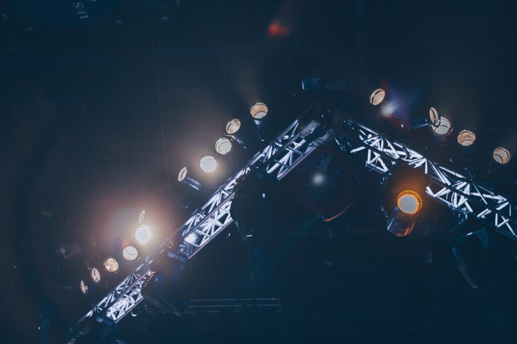 The Art of Drawing Readers In: Your attractive post title goes here Bright stage lights illuminate a concert venue, creating a vivid and celebratory atmosphere.